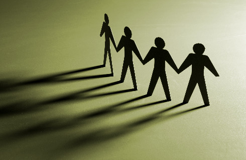 Line of green stylized people holding hands